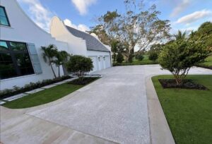 Luxury estate driveway featuring a clean, decorative concrete driveway with a smooth picture-frame border surrounding a textured main field.