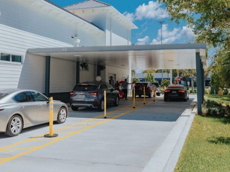 Commercial site showing concrete pavement with marked lanes and curbing at a drive‑thru facility